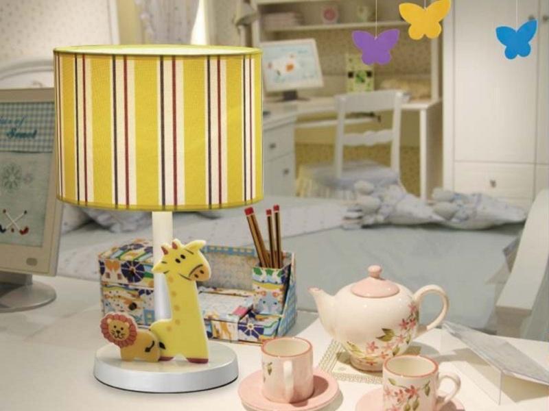 Child room decor with a giraffe lamp and a toy tea set.